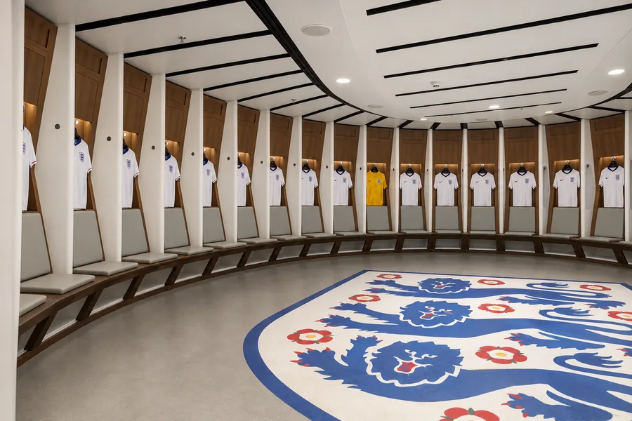 Wooden lockers and benches in the Wembley Stadium dressing room